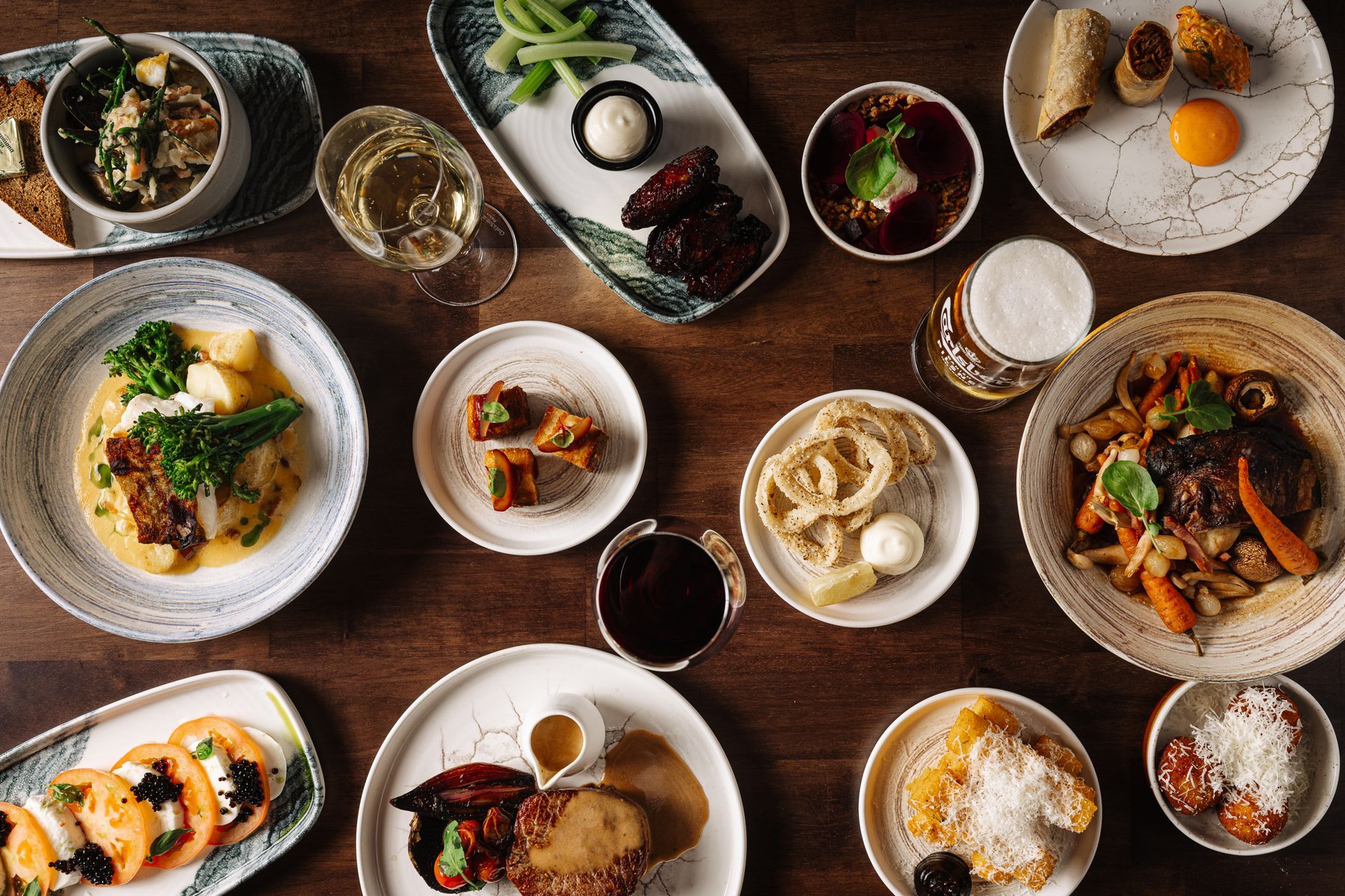 A table topped with plates of food and drinks.