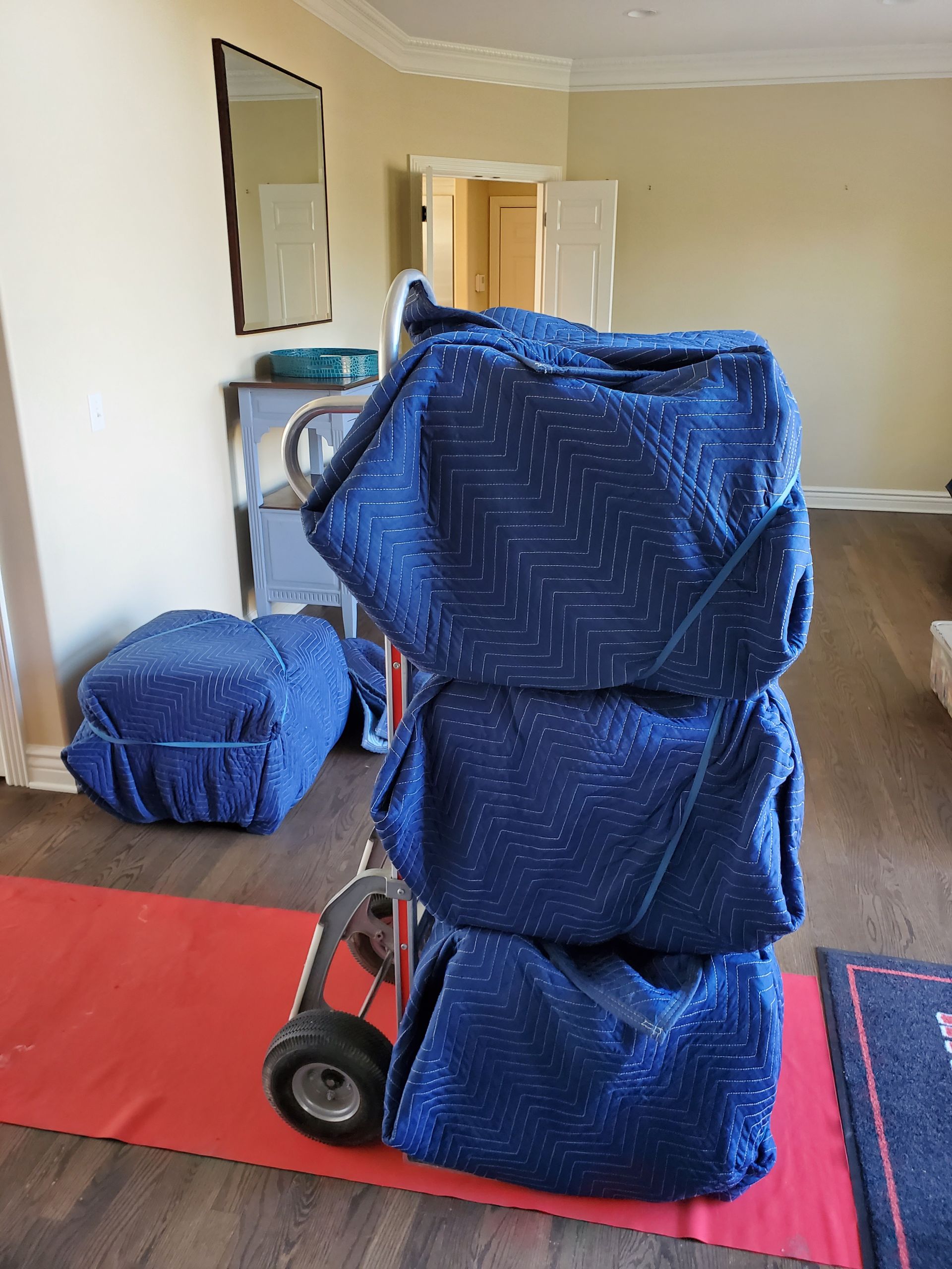 blue blankets are stacked on top of each other on a cart