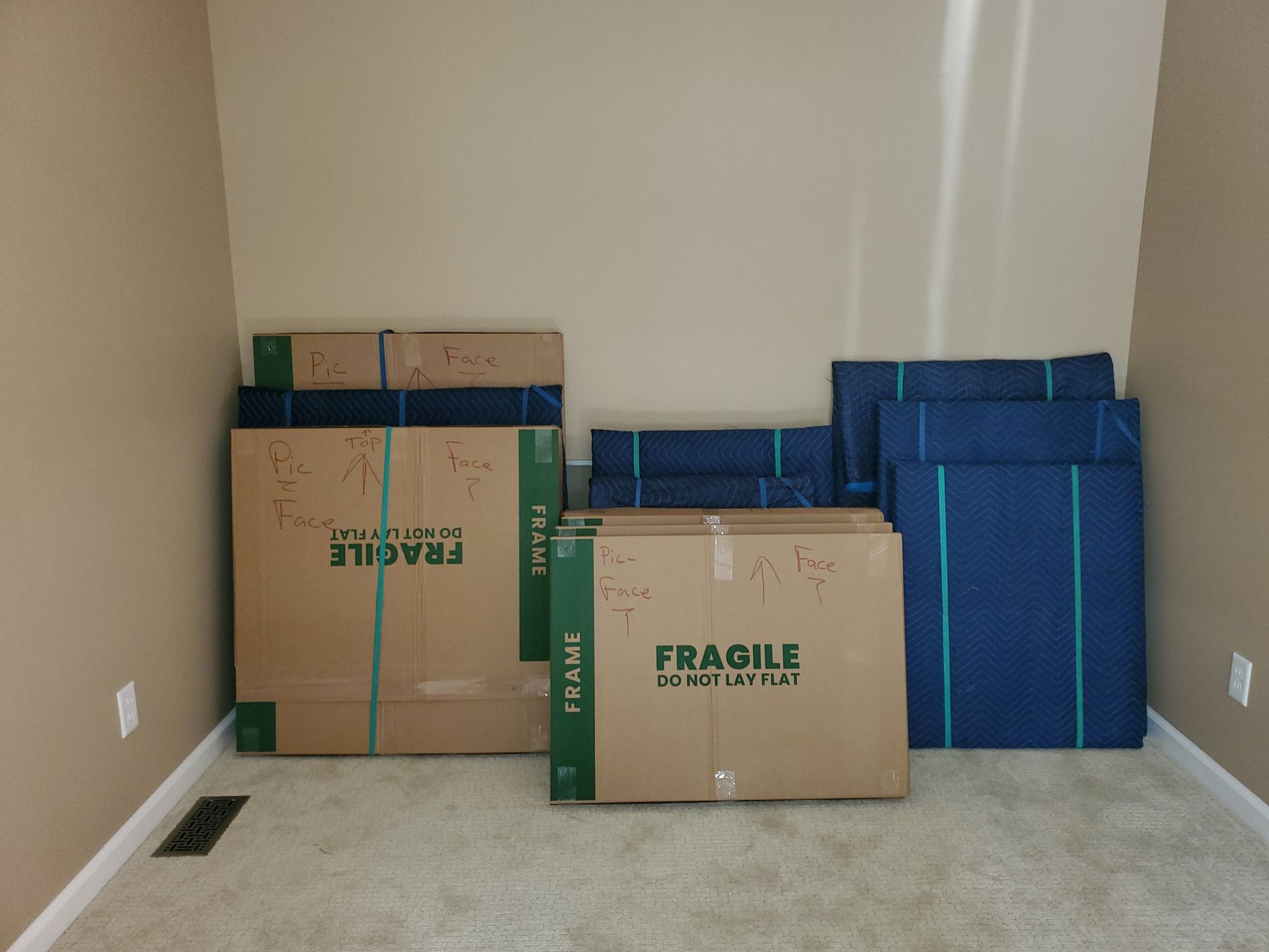 A room filled with cardboard boxes that say fragile