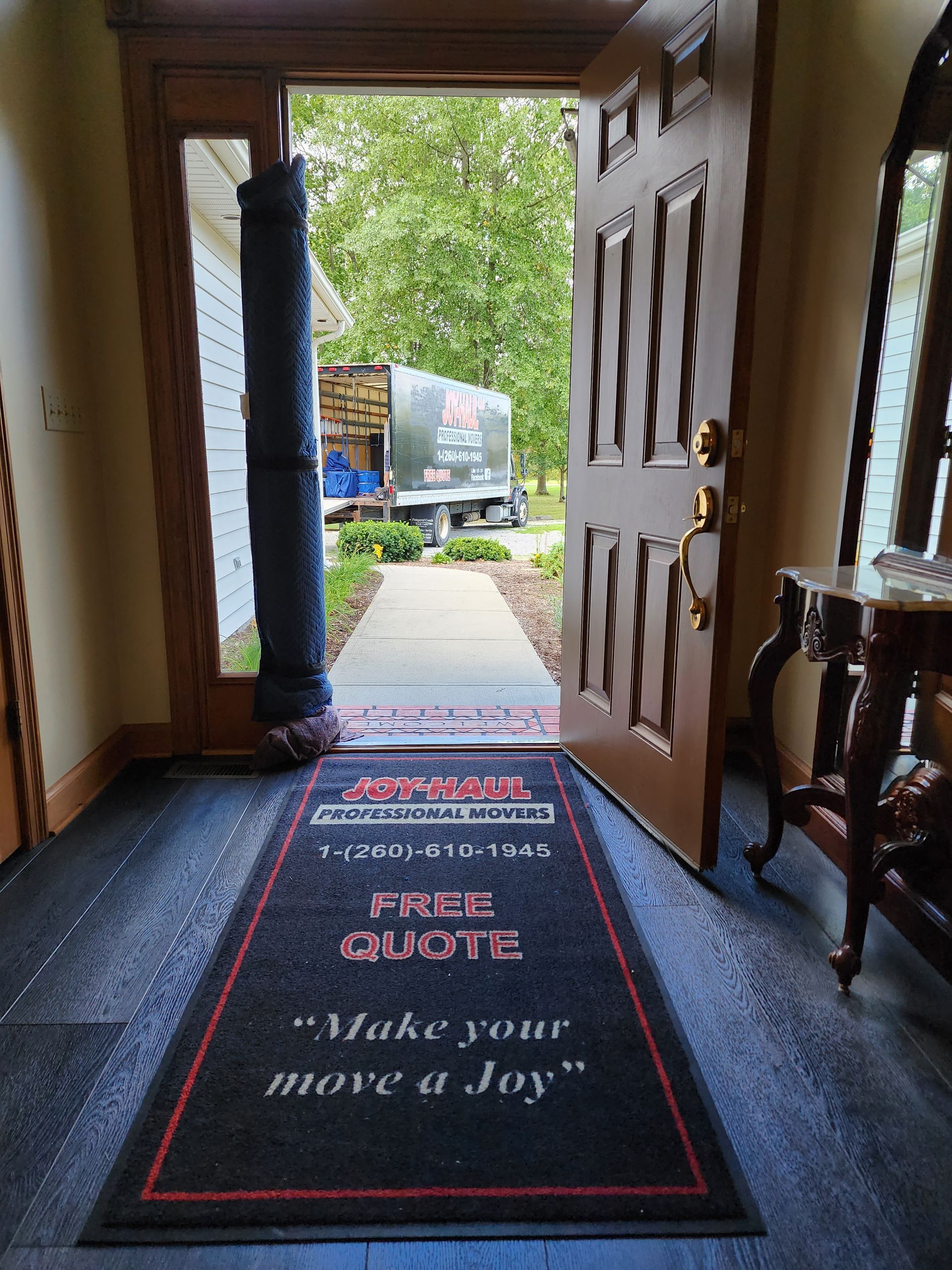 a doorway with a rug that says `` make your move a joy ''
