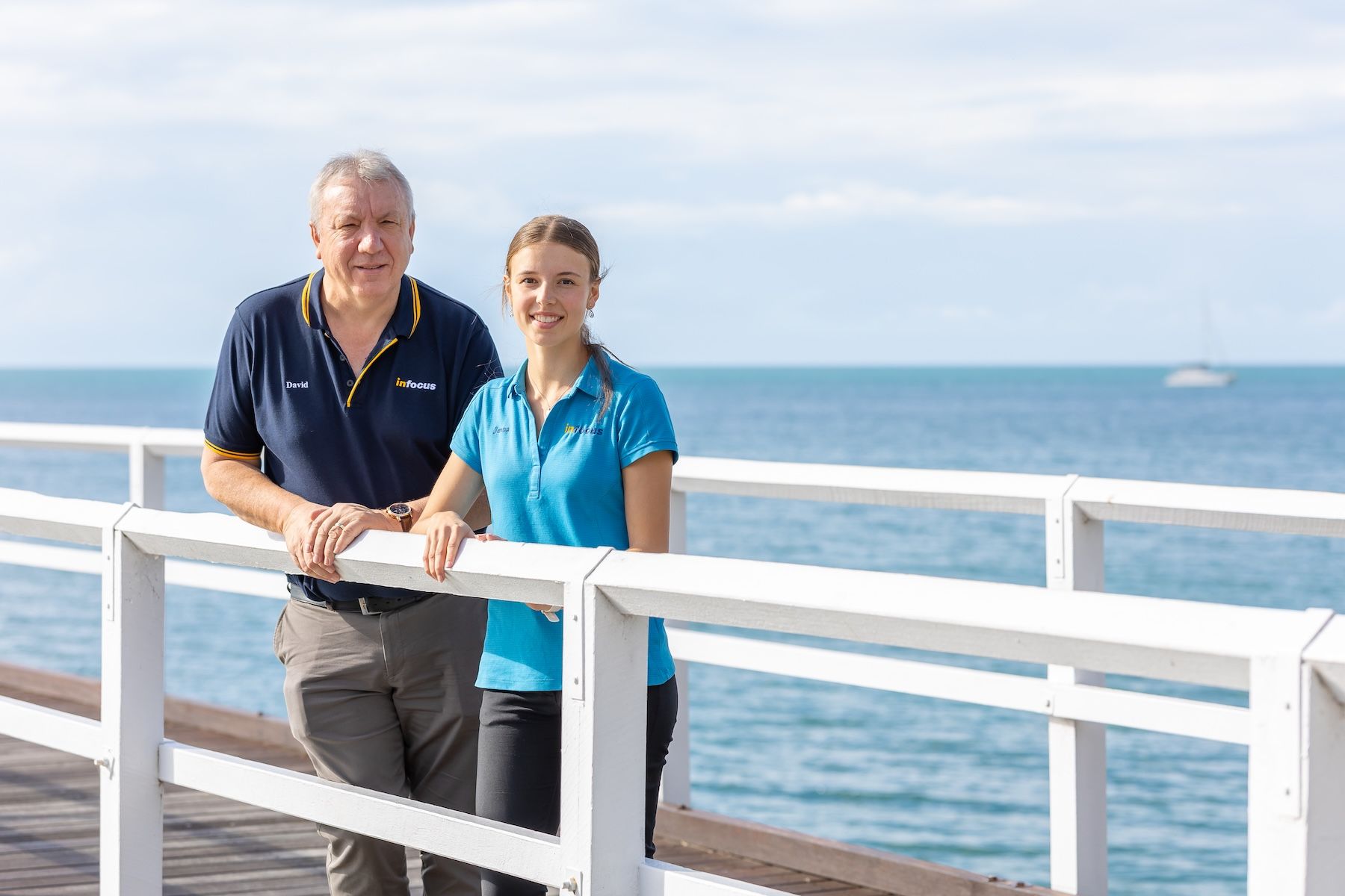 A Man Is Talking To An Elderly Couple In A Kitchen — Infocus Financial Advice Hervey Bay in Dundowran, QLD