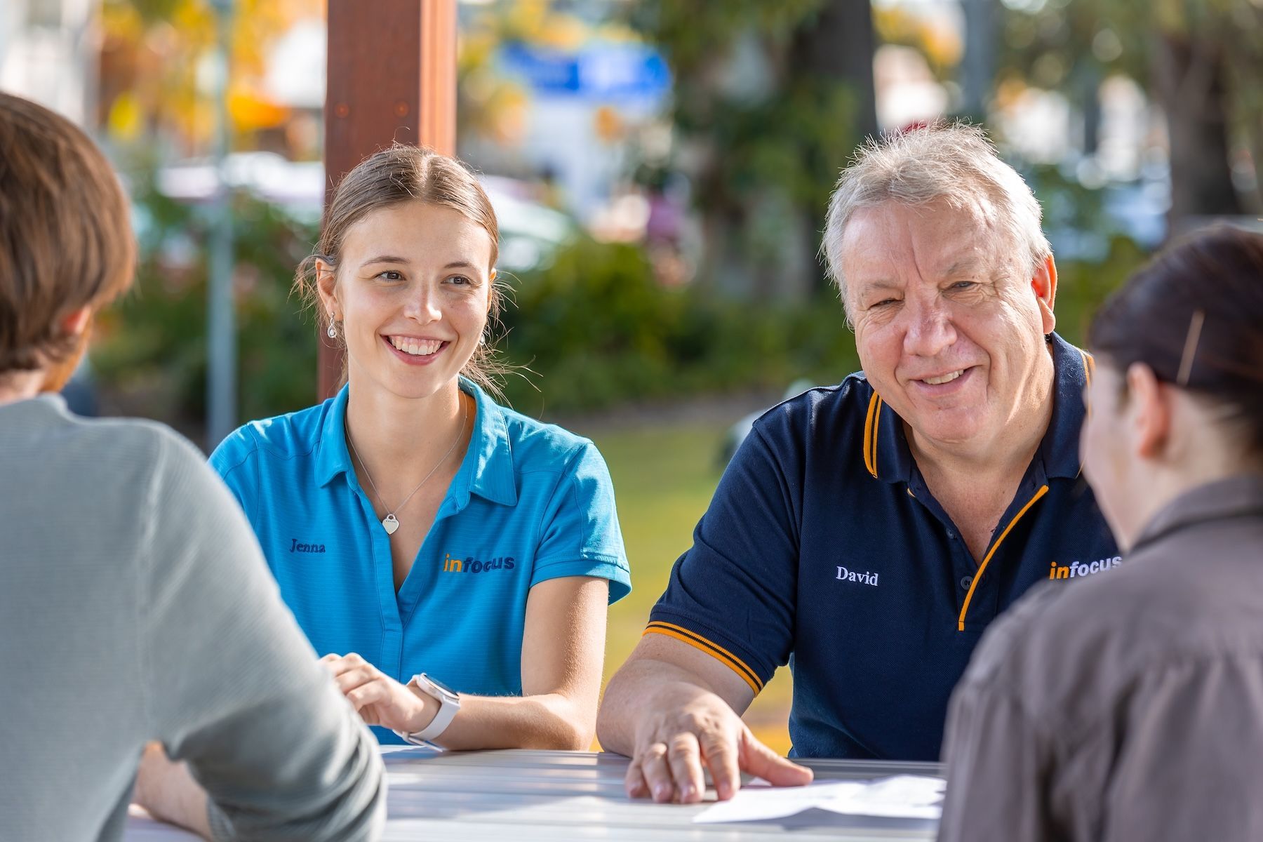 A Man In A Wheelchair Is Shaking Hands With A Woman — Infocus Financial Advice Hervey Bay in Dundowran, QLD