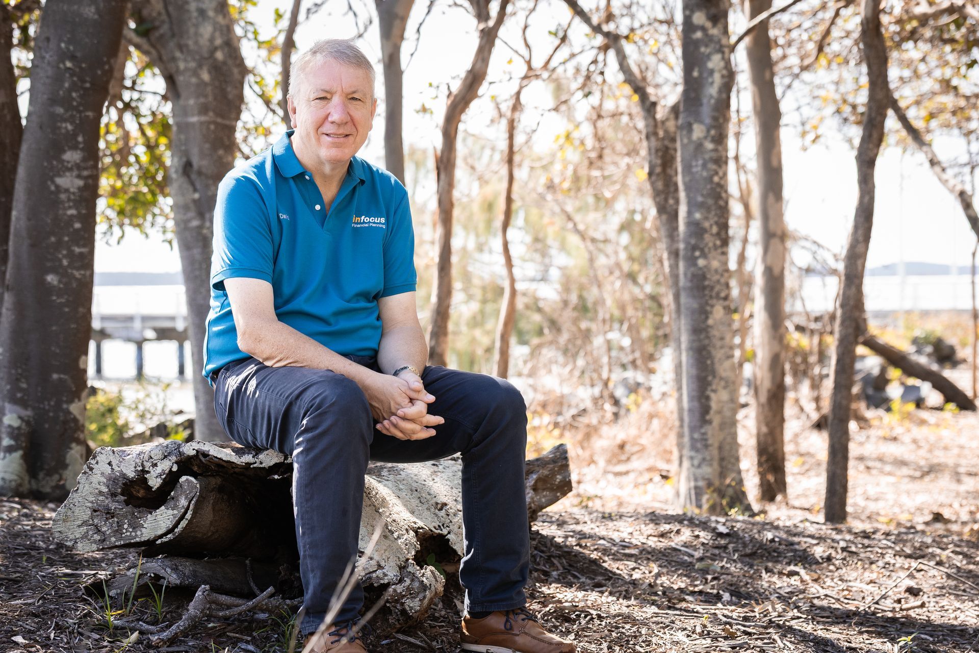A man sitting on a log — Infocus Financial Advice Hervey Bay in Dundowran, QLD