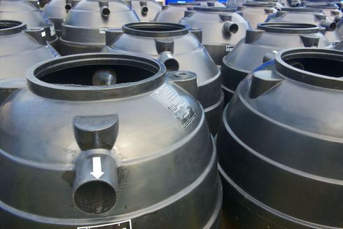 Black plastic septic tanks, ready for installation.