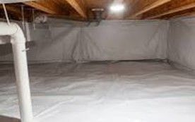 Empty, freshly painted basement room with carpet and recessed lighting; door to other room.