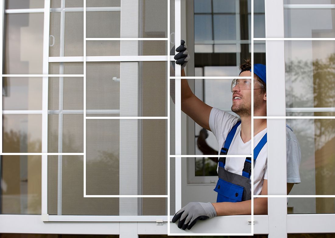 A man is installing a mosquito screen on a window.