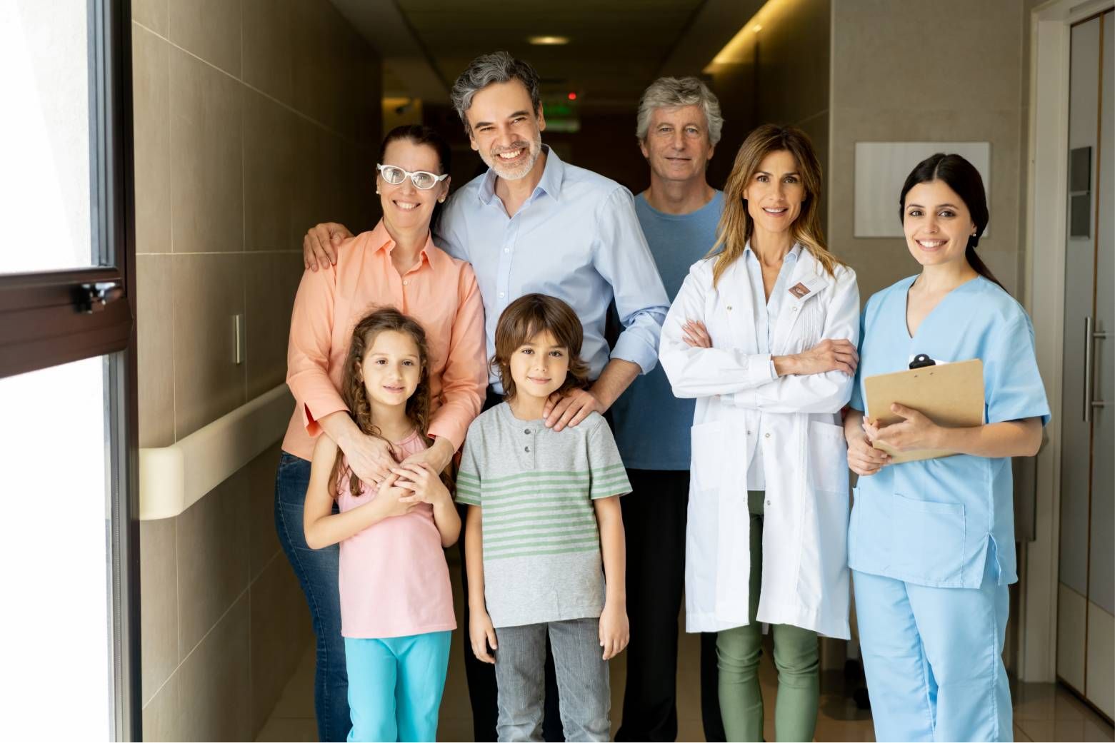 Family and medical staff standing together in a hospital hallway