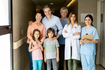 Family and medical staff standing together in a hospital hallway