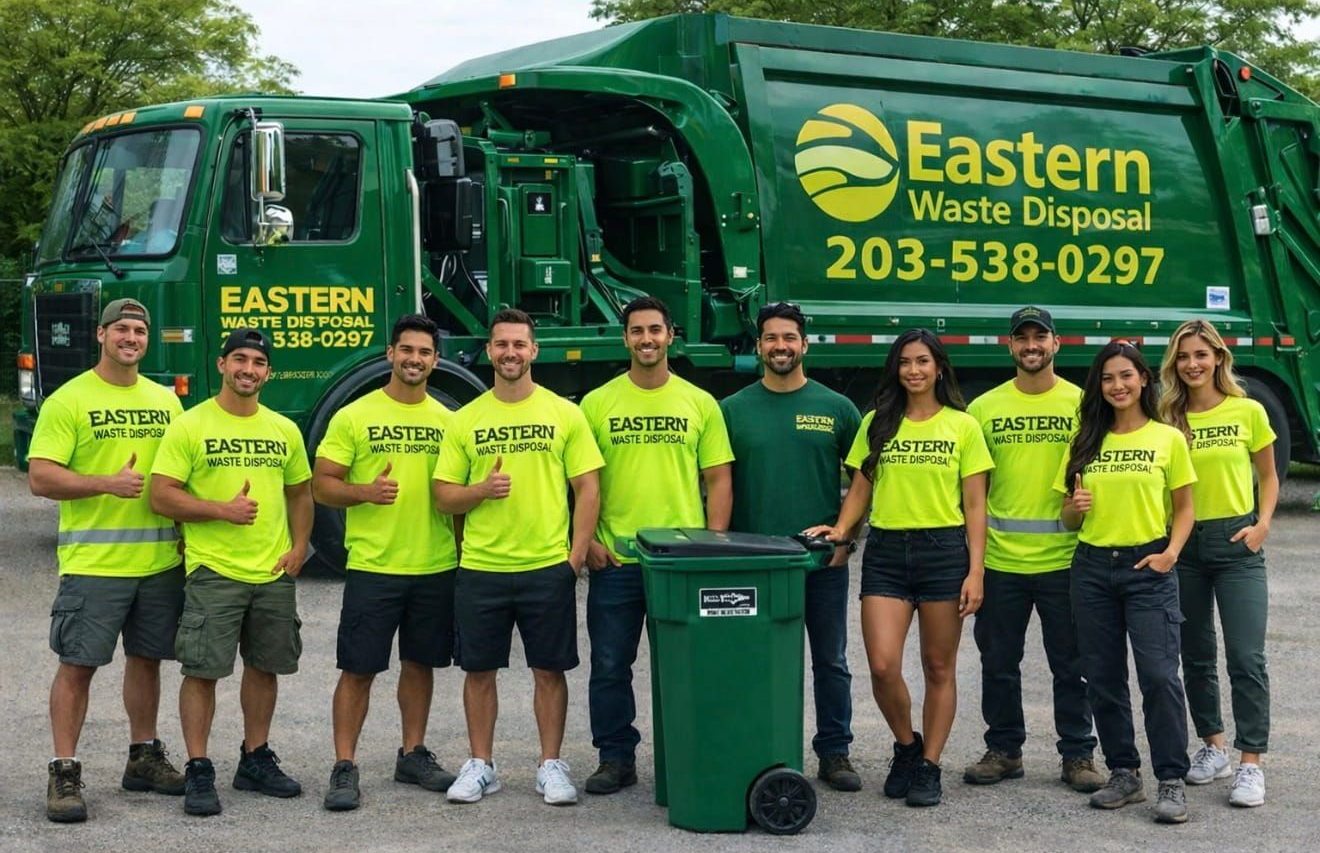 A group of people in branded yellow and green shirts pose with a green Eastern Waste Disposal truck and a waste bin.