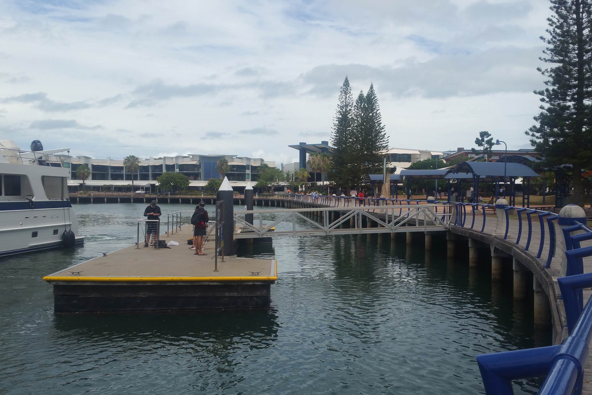 view of a lake with boats and a bridge