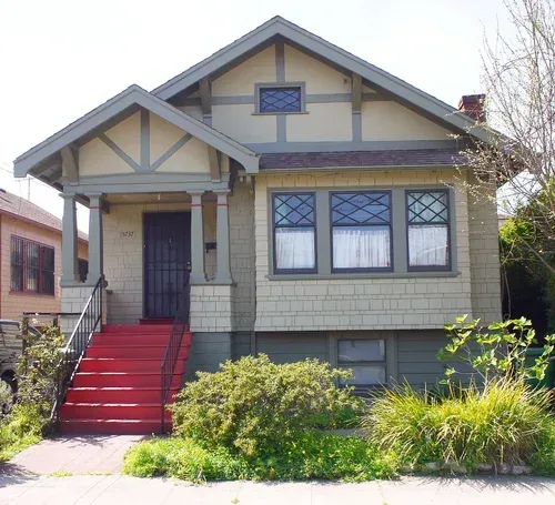Exterior painting of two-story Craftsman house with red stairs, green siding, and a small front yard.