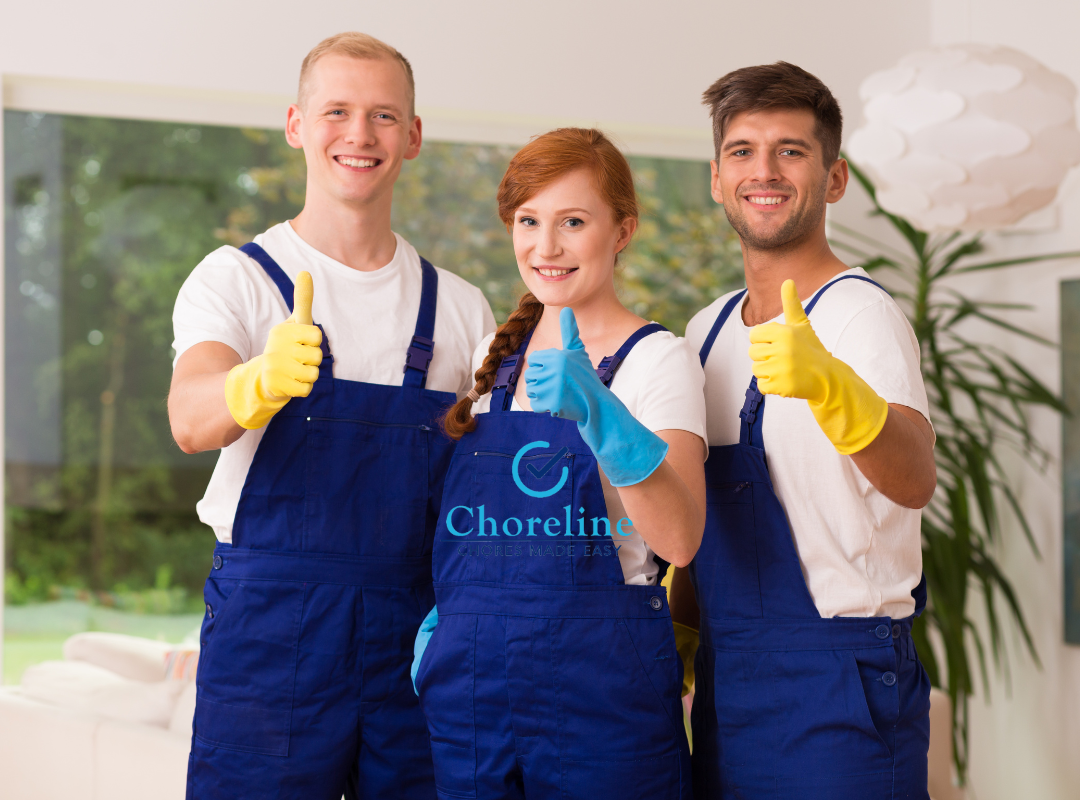 three cleaners are posing for a picture and giving a thumbs up .