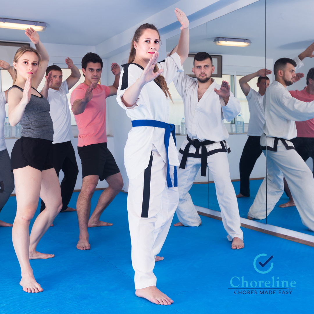 a group of people are practicing martial arts in a choreline gym