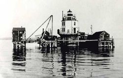 old photo of the construction pier built around the lighthouse