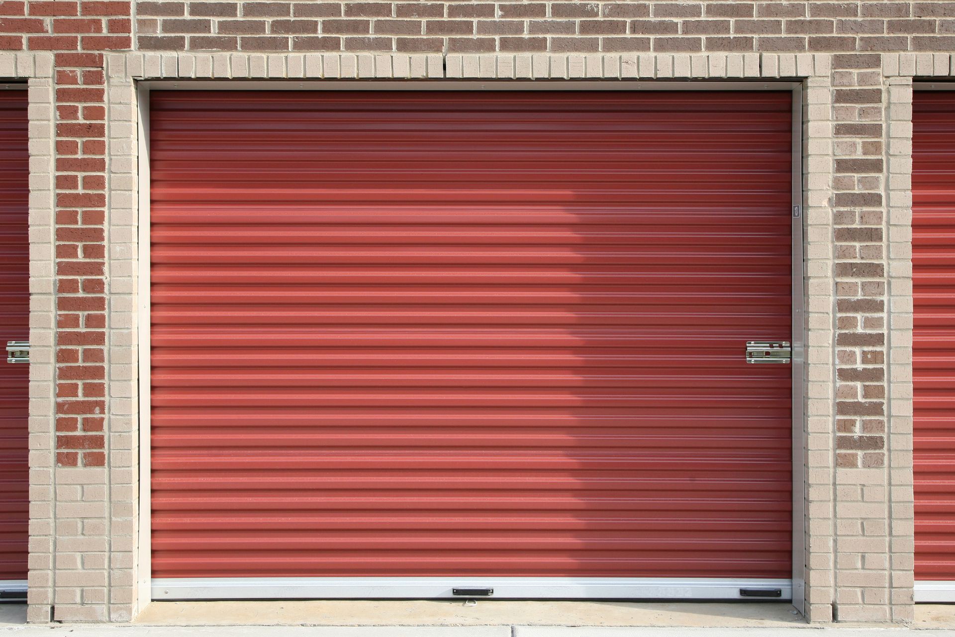 A Red Garage Door with A Brick Wall