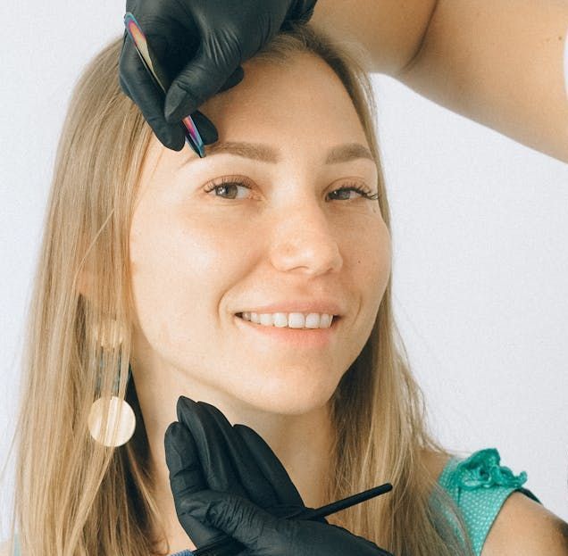 Esthetician carefully applying a chemical peel to a client’s face for skin resurfacing and renewal