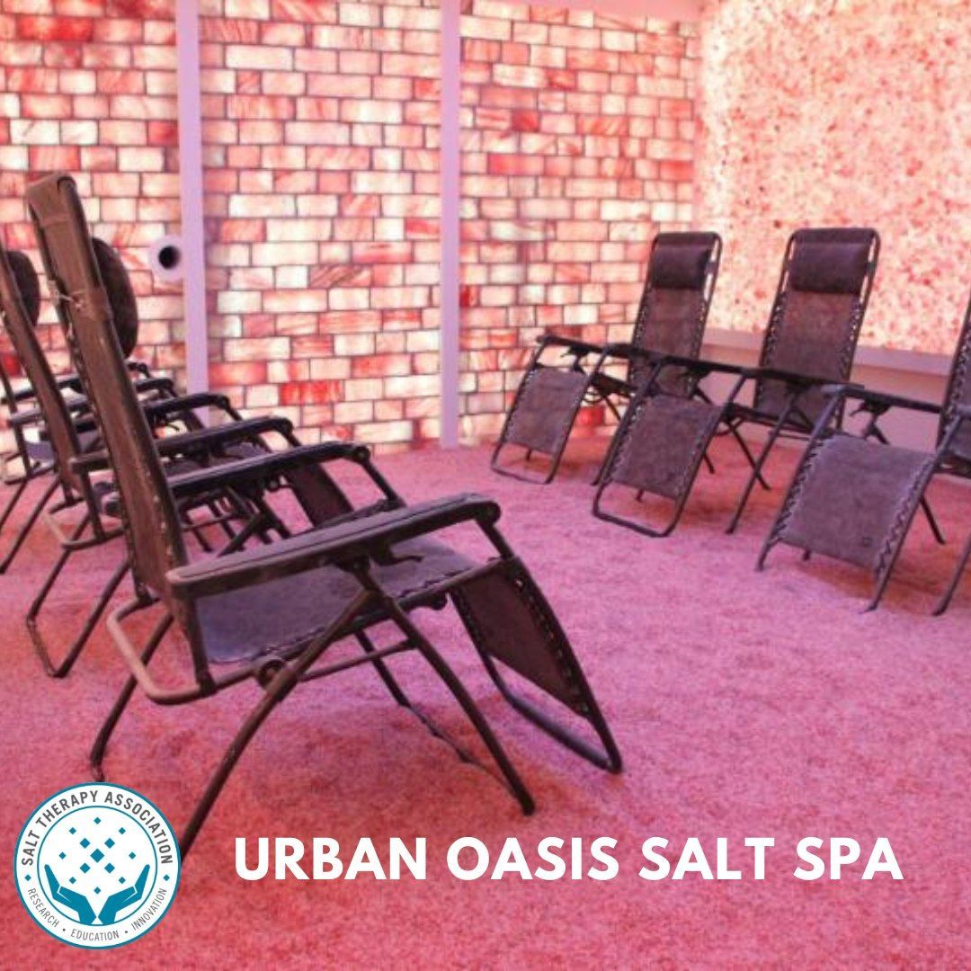 Peaceful salt room with glowing pink salt walls and cozy recliners.