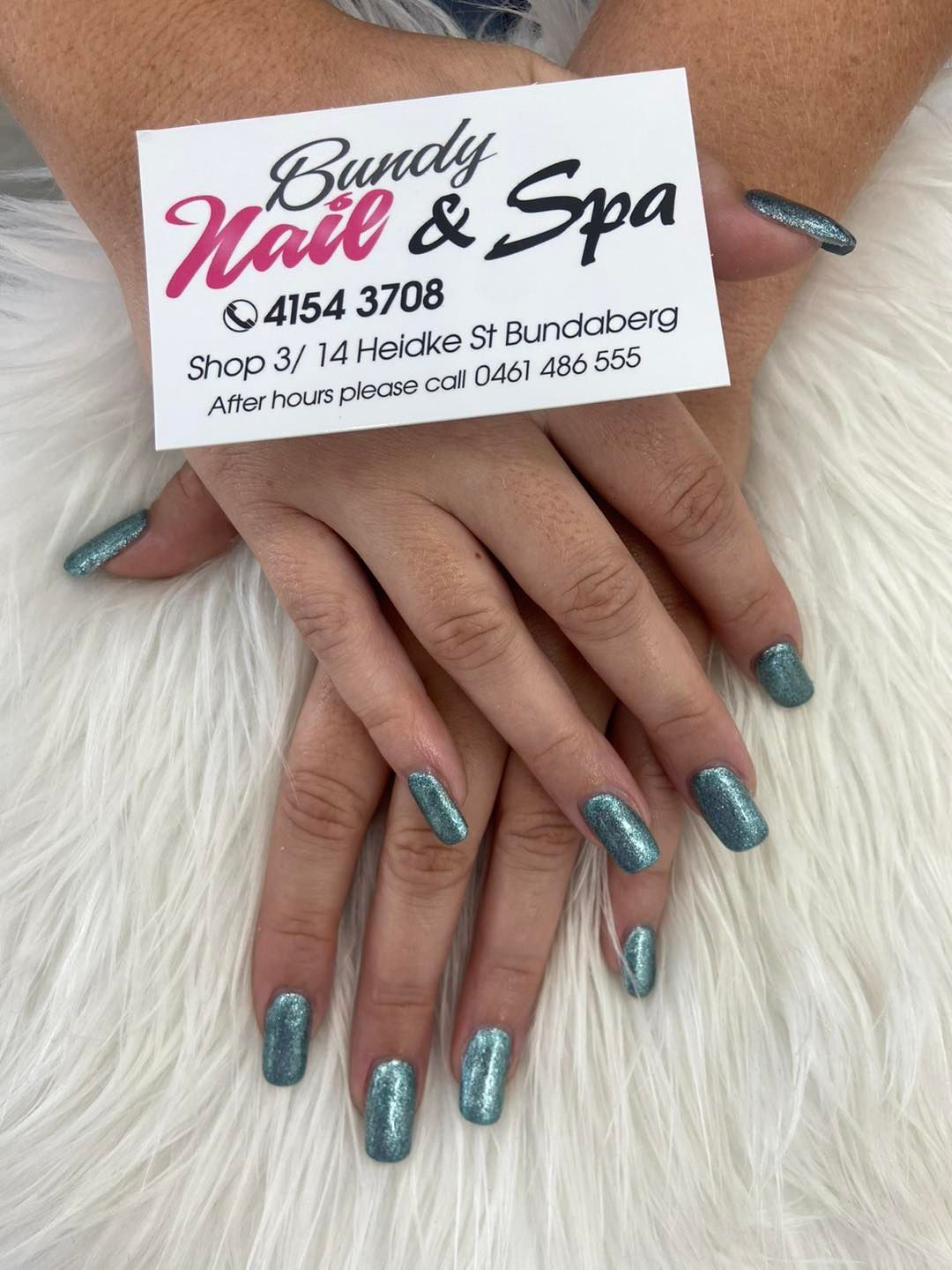A Woman's Hands With Glitter Nails And A Business Card— Bundy Nail & Spa in Avoca, QLD
