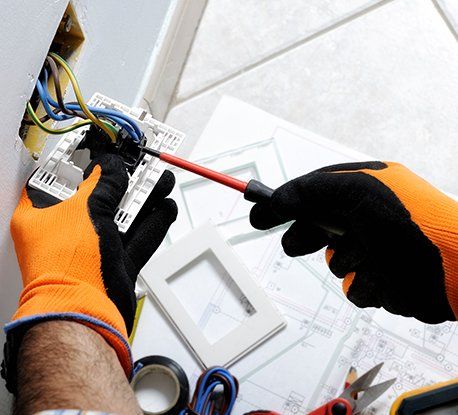 Electrician Working Safely on Switches and Sockets — Clairsville, OH — Bryan Electric Inc.