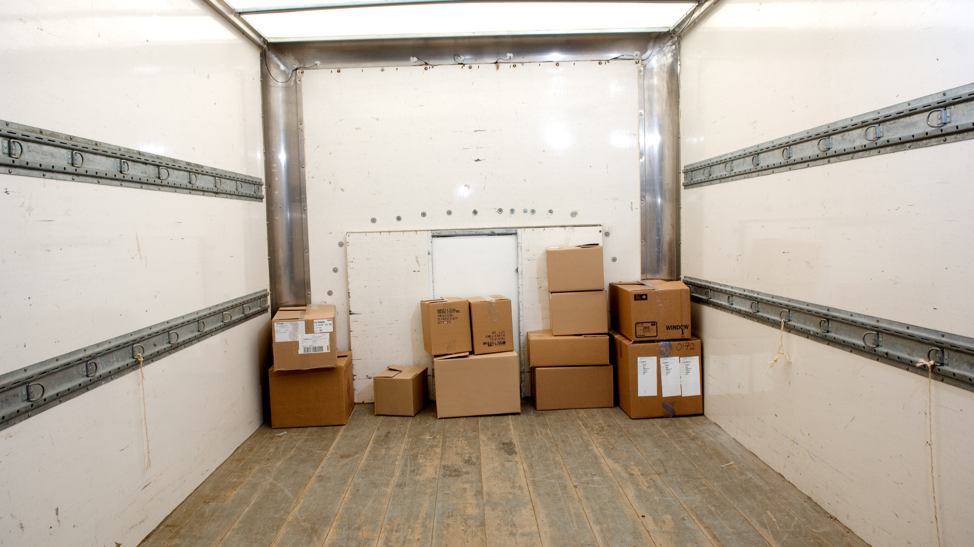 The inside of a moving truck filled with cardboard boxes