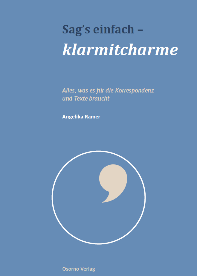 Ein blauer Buchumschlag mit einem Komma in einem Kreis