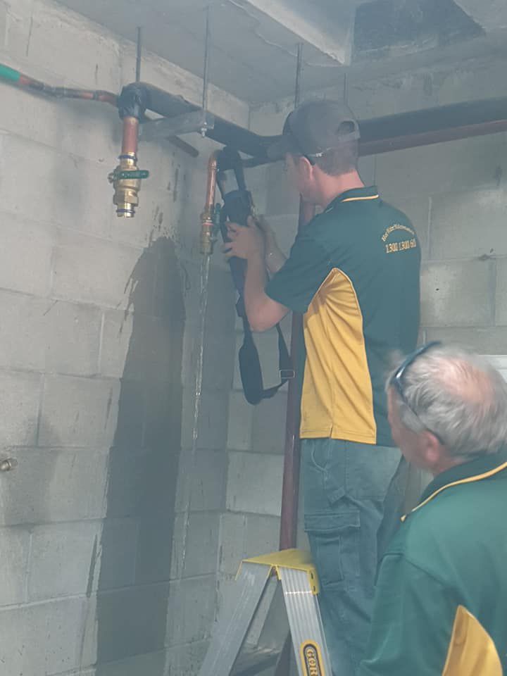 Technician fixing the pipe — Hot Water System Sales & Installation in Port Macquarie