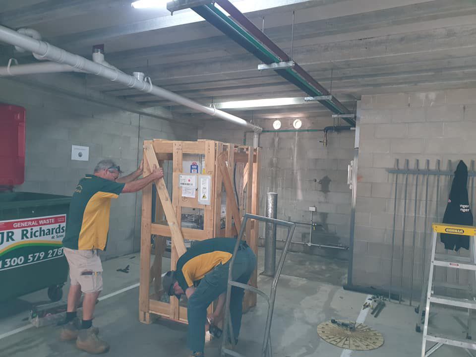 Team installing hot water heater system — Hot Water Systems in Wauchope, NSW