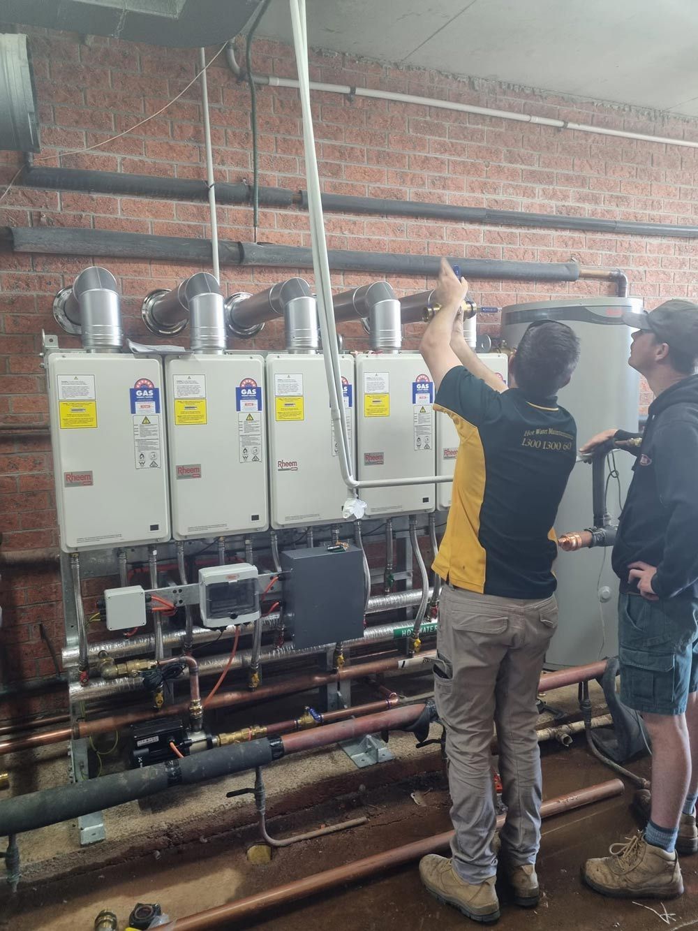 Technician fixing the heater boiler — Hot Water Systems in Crescent Head, NSW