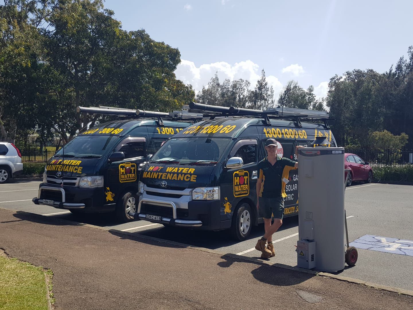 Two business van and technician holding hot water tank — Hot Water Systems in South West Rocks, NSW