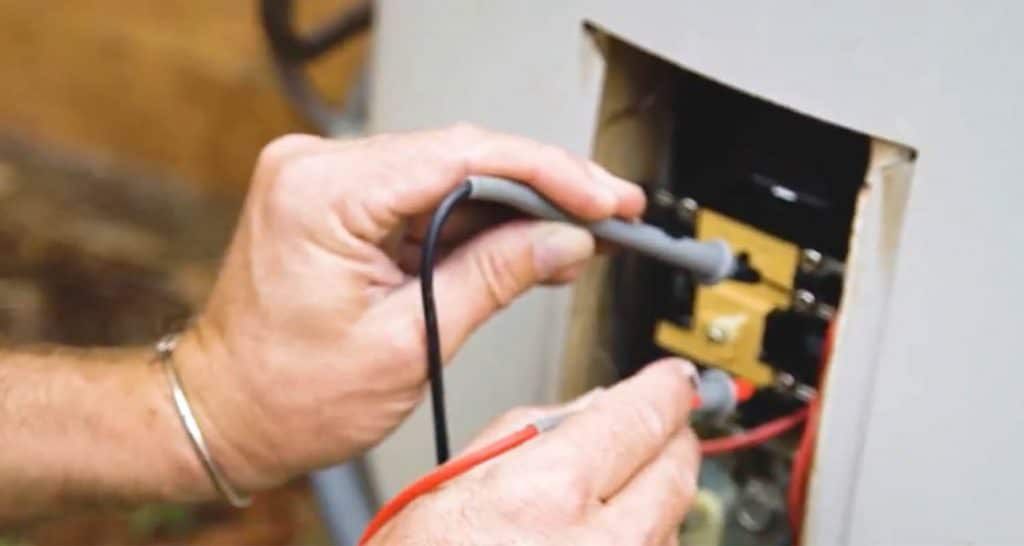 Plumber fixing the connection and wire of water heater — Hot Water Systems in Port Macquarie NSW