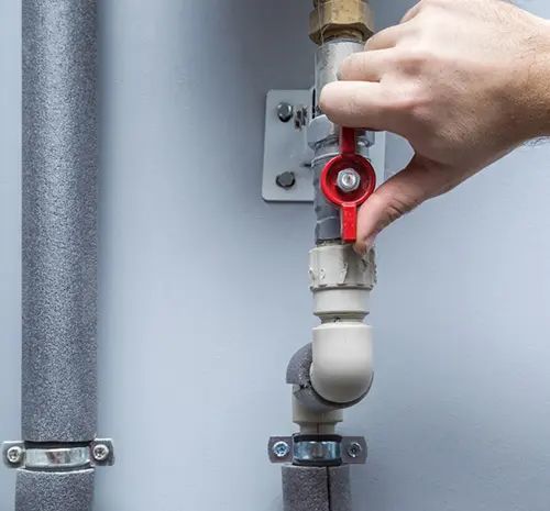 Man working at pipes — Hot Water Systems in South West Rocks, NSW