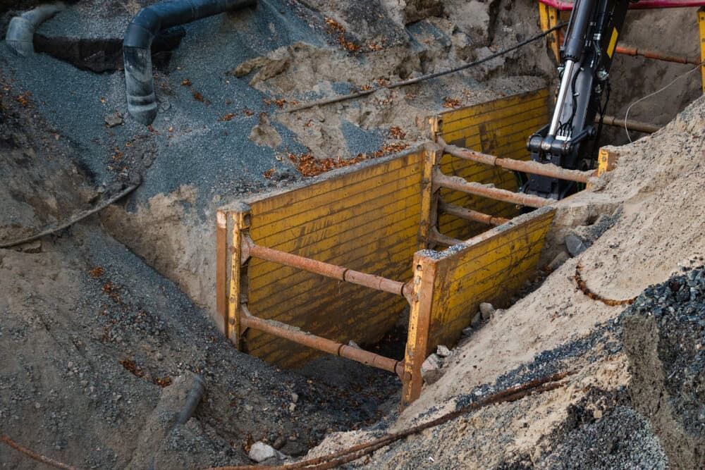 Yellow Trench Boxes in an Excavated Construction Site — Rhino Excavator & Bobcat Hire in Whitfield, QLD