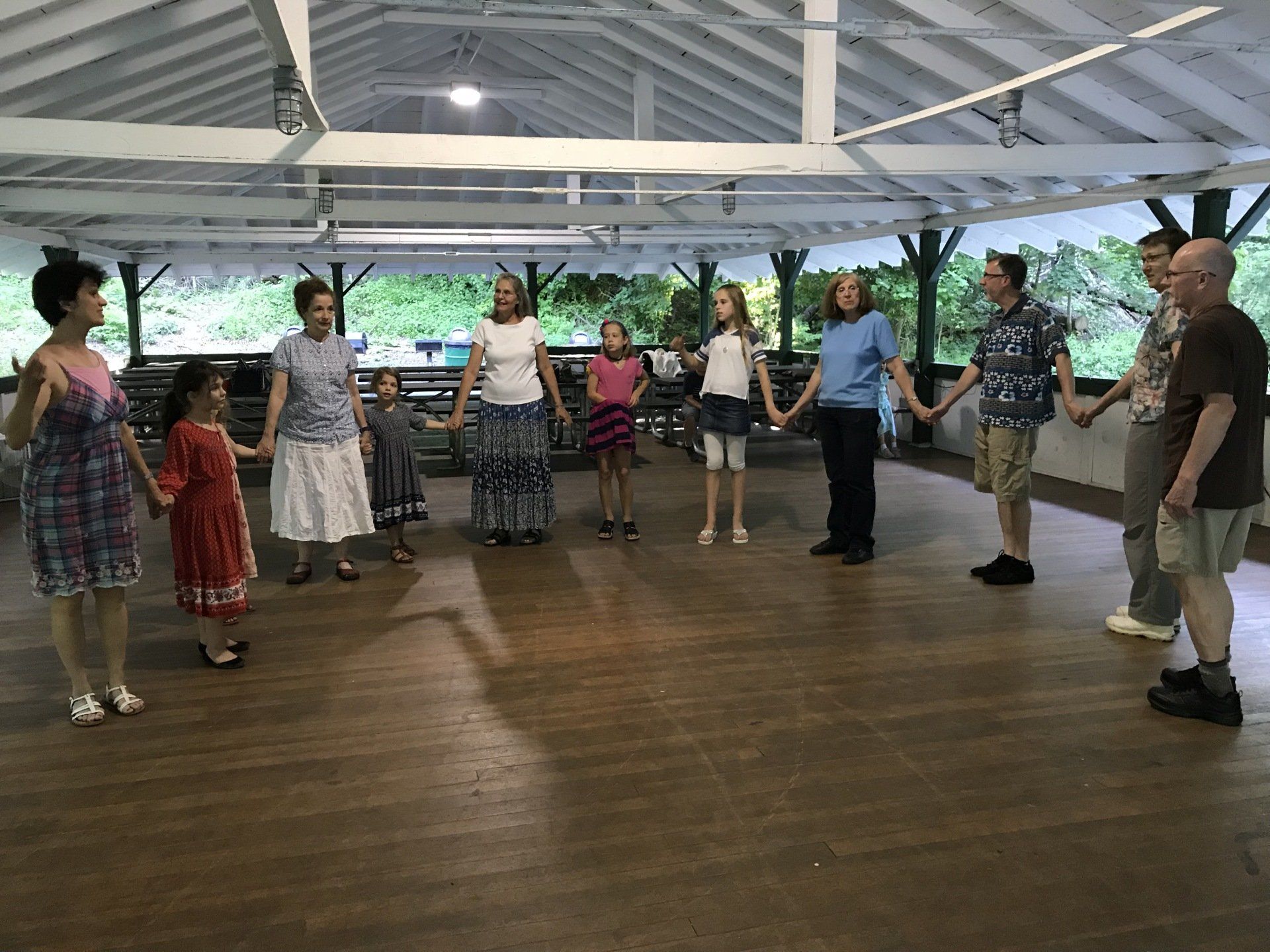 A group of people are standing in a circle holding hands.