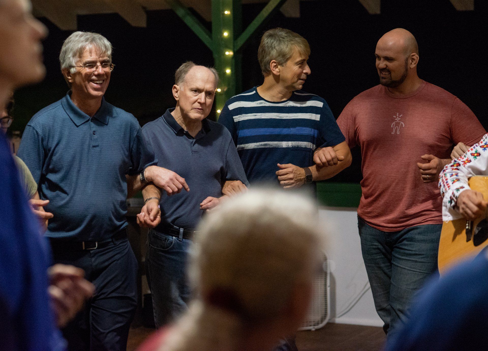 A group of men are standing next to each other in a room.