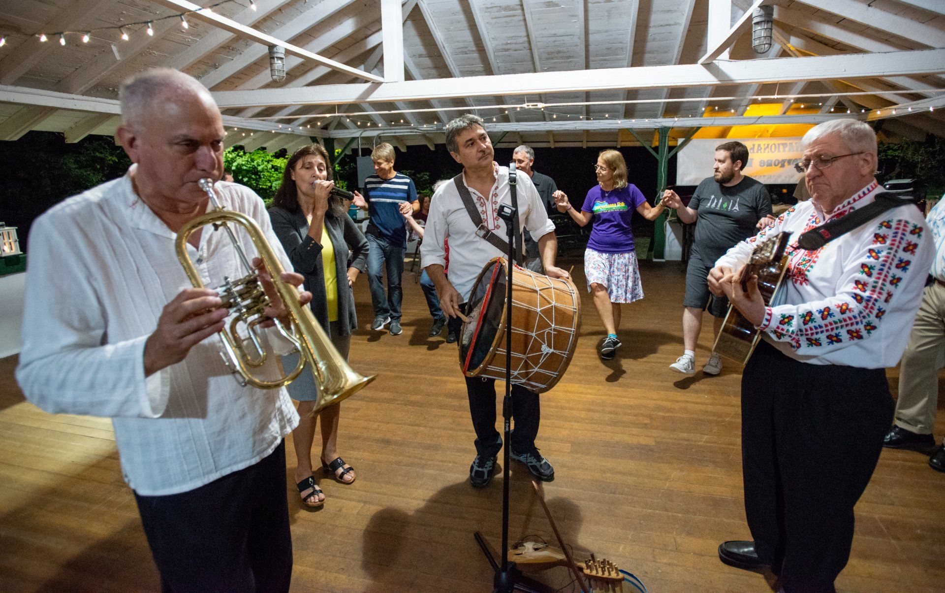 A group of people are playing instruments in a room.