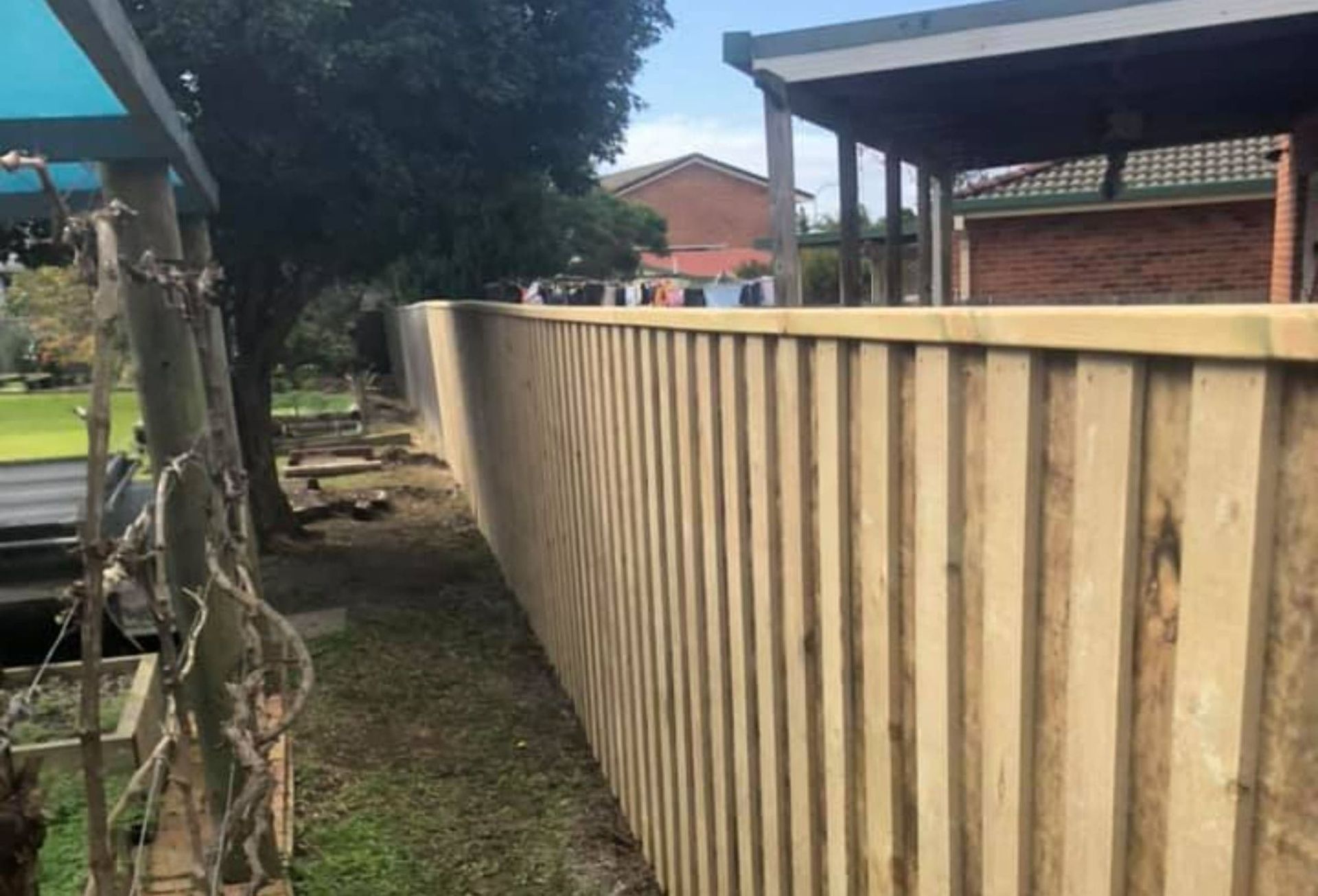 A Wooden Fence Is Being Built in Front of A House — D & B Fencing in Taree, NSW