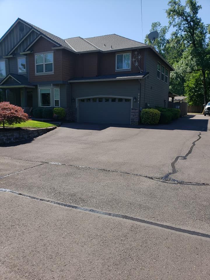 A large house with a driveway and a car parked in front of it