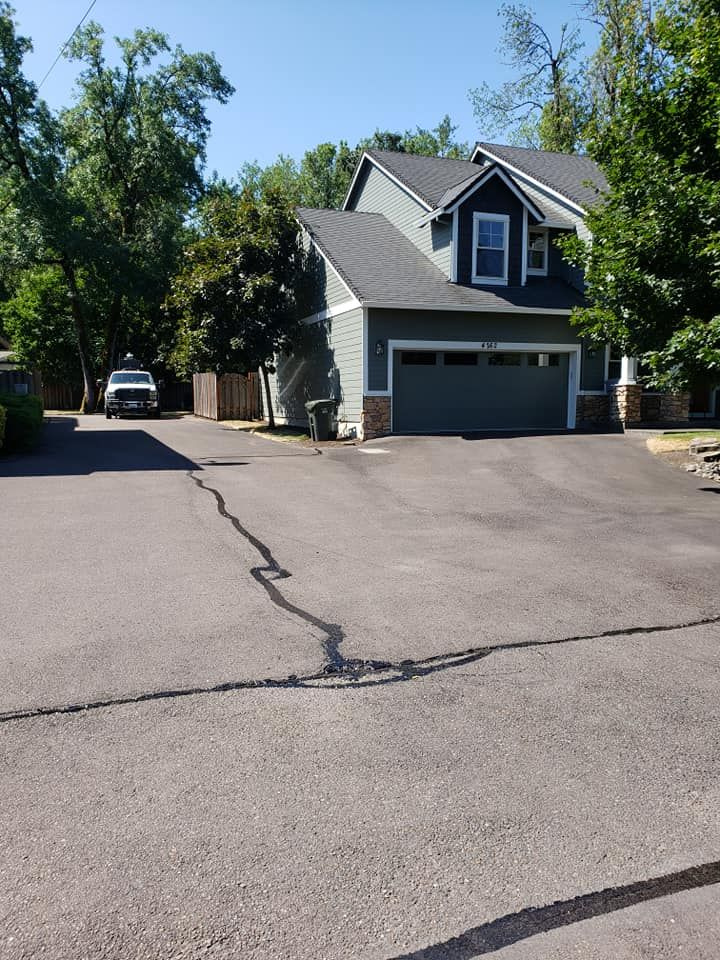 A house with a garage and a car parked in front of it