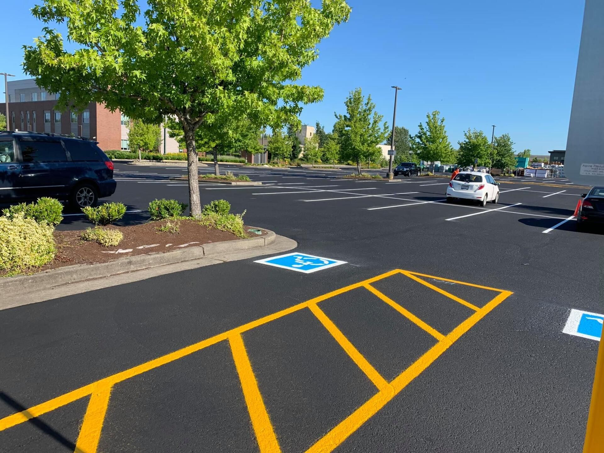 A parking lot with a handicapped parking spot painted on the road