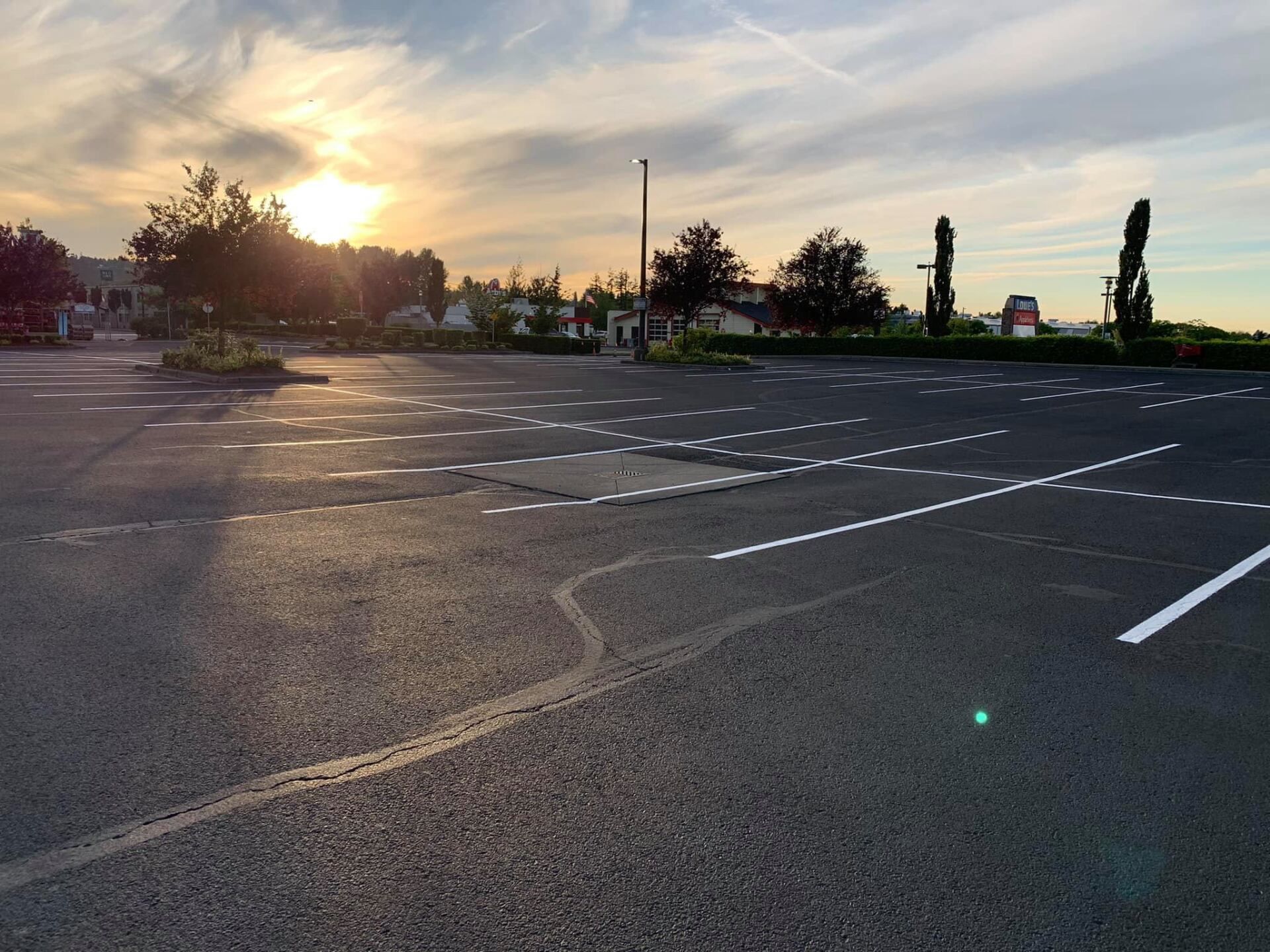 A parking lot with a sunset in the background