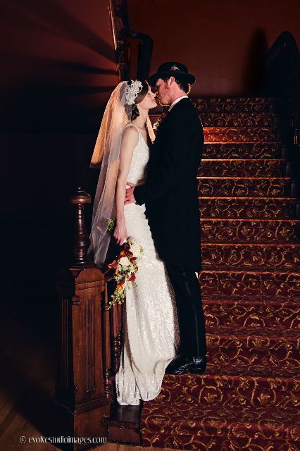 A bride and groom kissing on a set of stairs