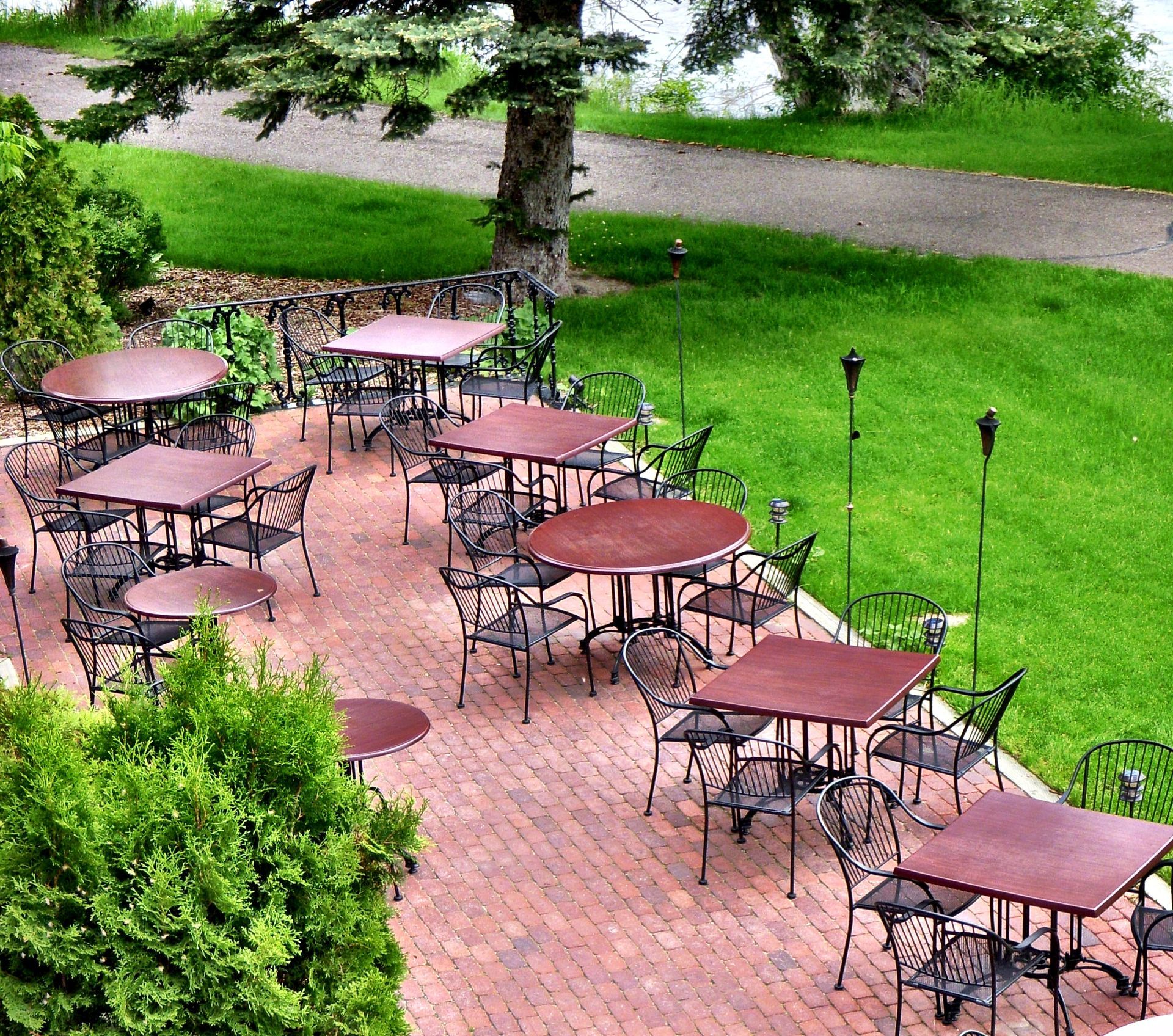 A lot of tables and chairs on a brick patio