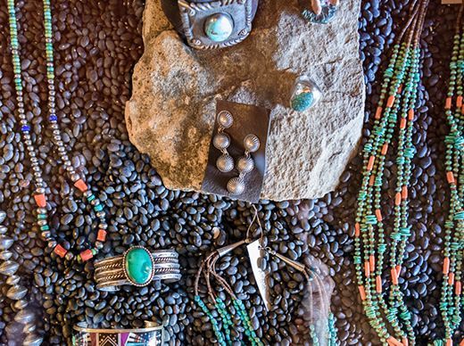 A variety of native american jewelry is displayed on a table.