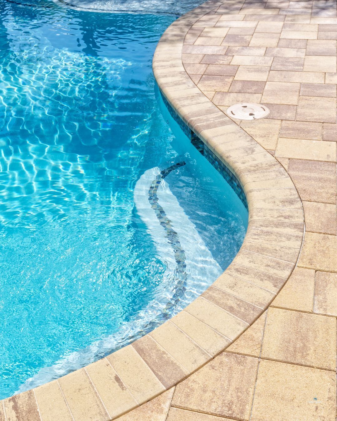 clean backyard pool with crystal clear water and outdoor tile.