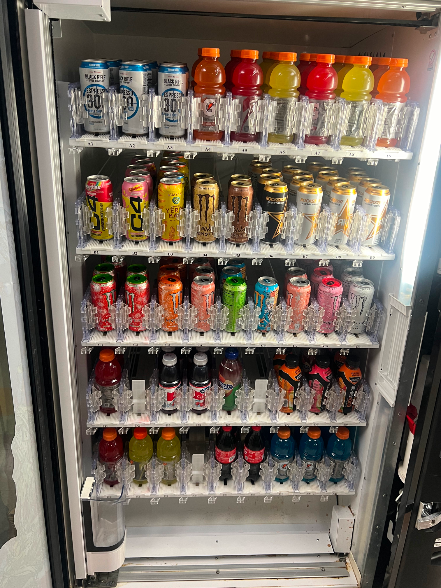 a vending machine filled with lots of cans and bottles of soda