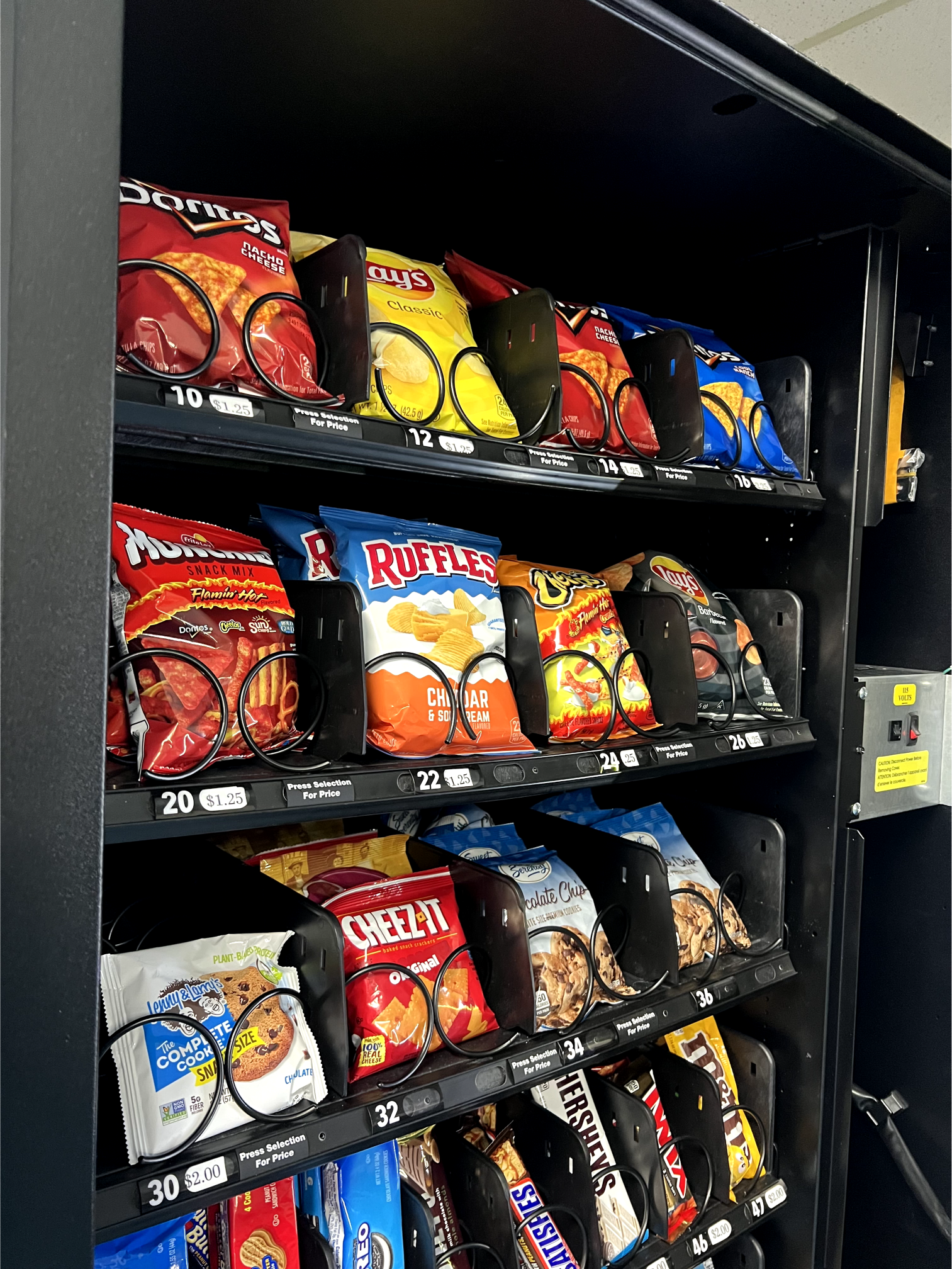 a vending machine filled with bags of chips and snacks