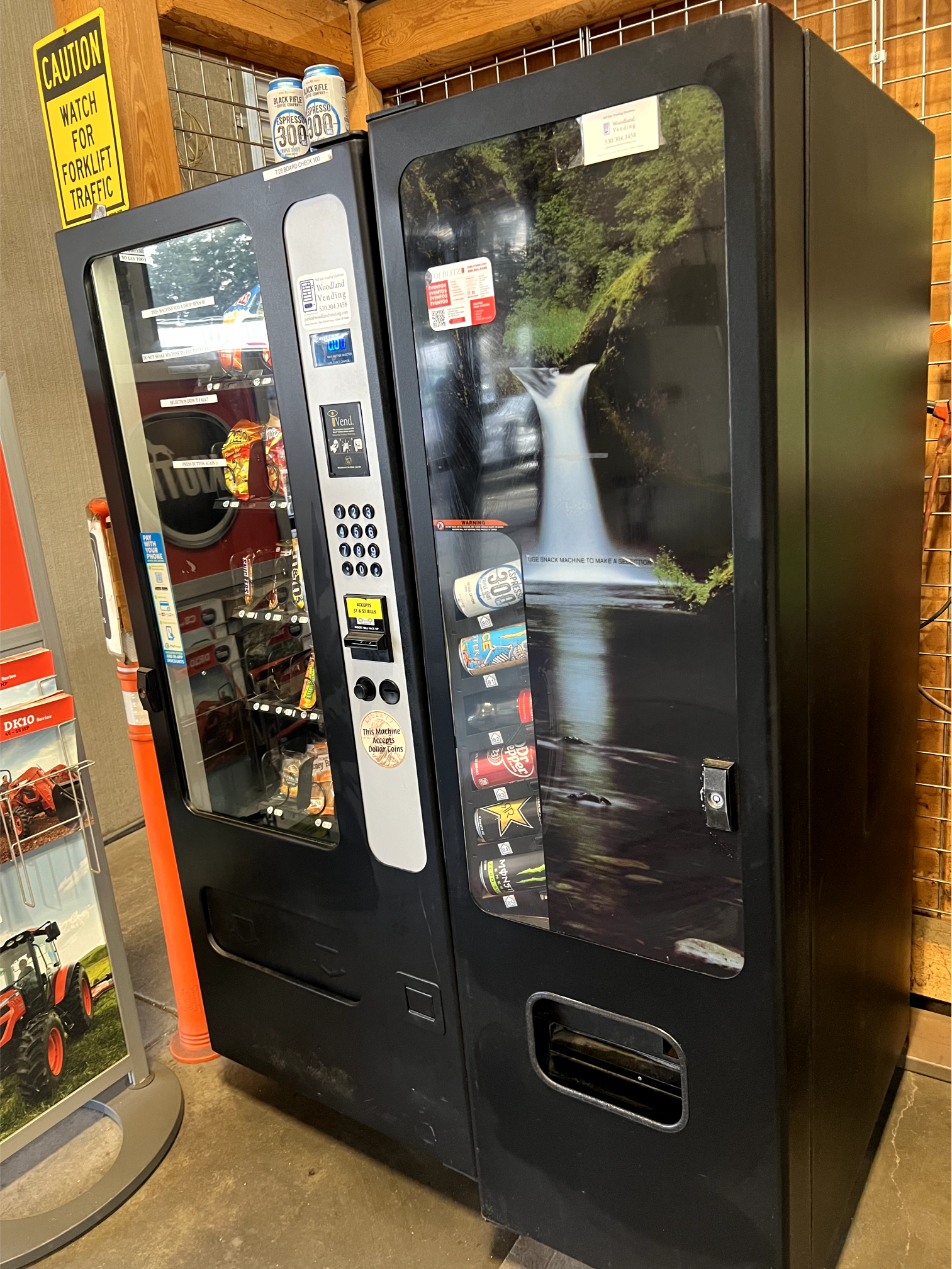 two vending machines are sitting next to each other in a room