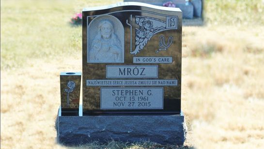 A gravestone in a cemetery with the name mroz on it
