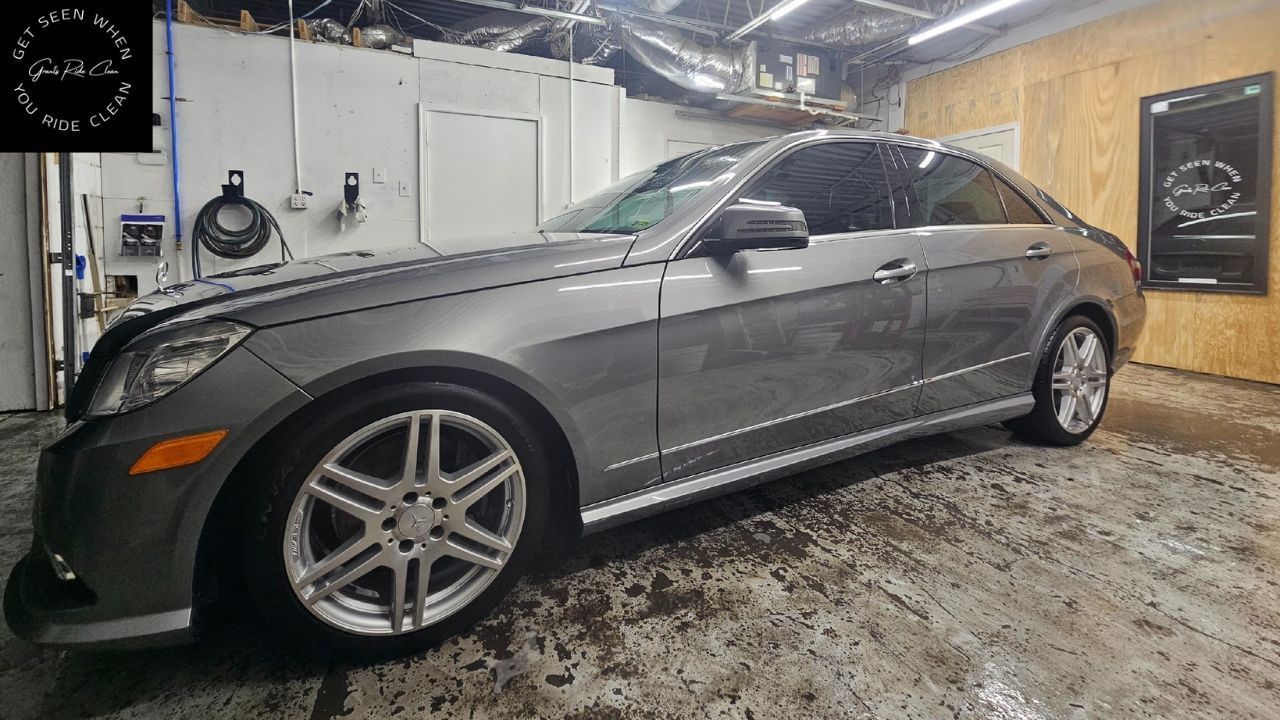 A grey Mercedes-Benz E-Class sedan parked inside a garage.