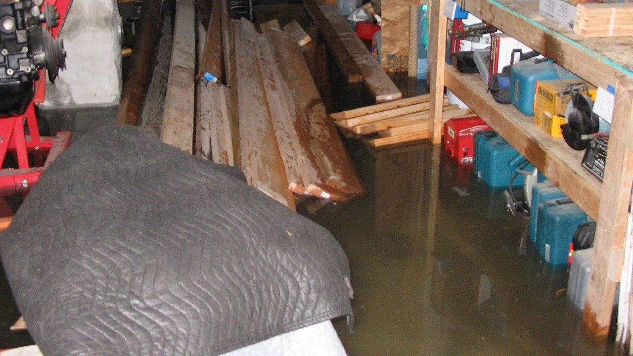 A flooded garage filled with wood and tools